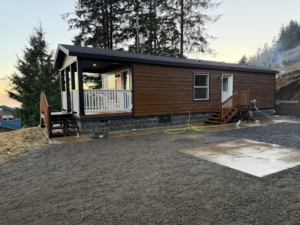 An exterior home renovation project with a new deck and landscaping preparation by United Property Improvement in Eugene, OR.