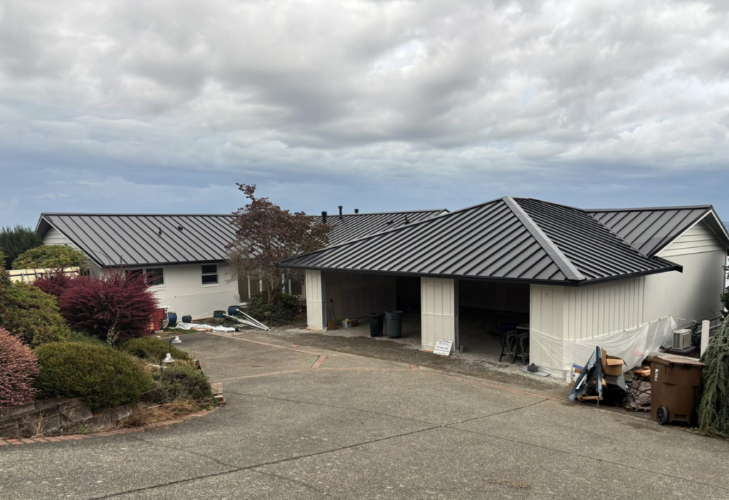 Exterior home renovation featuring a new metal roof and garage by Gregg Hoffman Construction Inc. in Tacoma, WA