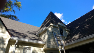 A ladder against a house, indicating exterior home repair or roofing work by Xavier Roofing & Remodeling in Dayton, OH.
