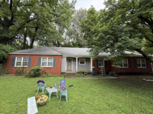 A handyman performing exterior house cleaning and renovation services for All Pro Roofing and Renovations in Sachse, TX.