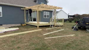 An exterior view of a house with a wooden deck and a partially built pergola by M&M Handyman Services LLC in Clarksville, TN.
