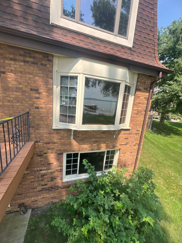 The exterior of a house showcasing new bay windows installed by Thebco Windows, Doors & Siding in Madison, WI.