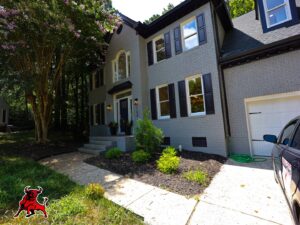 A beautifully painted gray brick house exterior by Bull City Painting & Roofing in Durham, NC