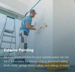 A handyman from Paint & Rollers performing exterior house painting with a roller in Roanoke, VA