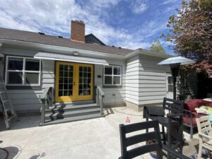 Exterior of a house with a ladder, suggesting painting or deck repair services by No Delay SVCS in Pocatello, ID.