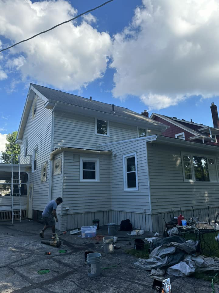 A worker performing exterior house painting services for Power Pro Painting in Cleveland, OH