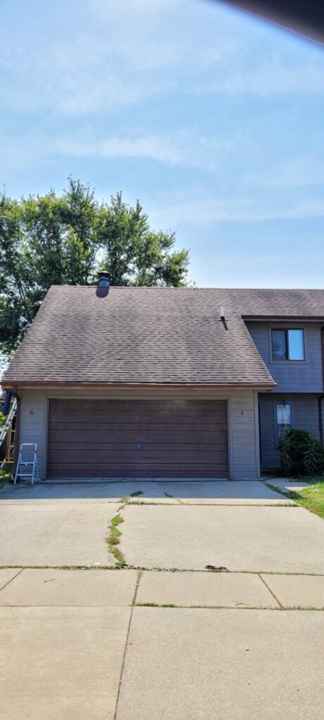Exterior of a house with a ladder, indicating painting or repair work by FG Drywall, Finishing and Painting in Champaign, IL.