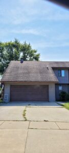 Exterior of a house with a ladder, indicating painting or repair work by FG Drywall, Finishing and Painting in Champaign, IL.