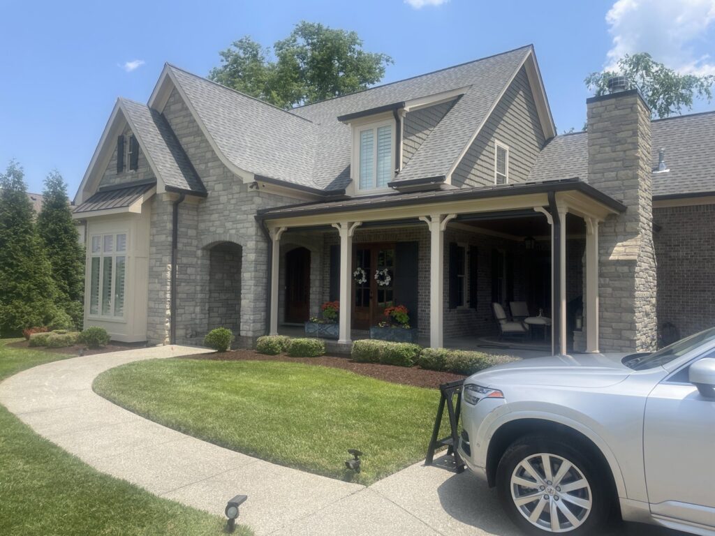 The exterior of a large house with stone and siding, painted by Harpeth Painting, LLC. in Nashville, TN.