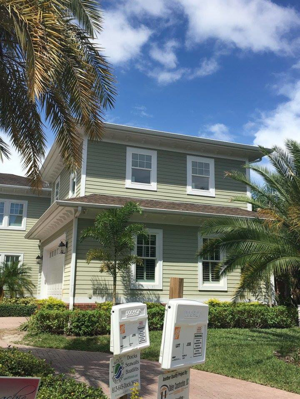 Exterior view of a house with project signs indicating work by Daley Construction, LLC in Tampa, FL.