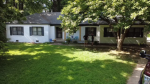 Workers on site during an exterior house renovation project by All Pro Roofing and Renovations in Sachse, TX.