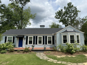 A freshly renovated house exterior with new roofing and siding by Parker Painting Company in Edmond, OK.