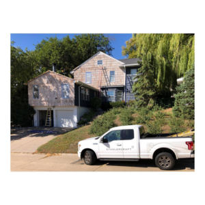 An exterior house renovation project in progress with a StadlerCraft truck parked nearby in Bloomington, MN.