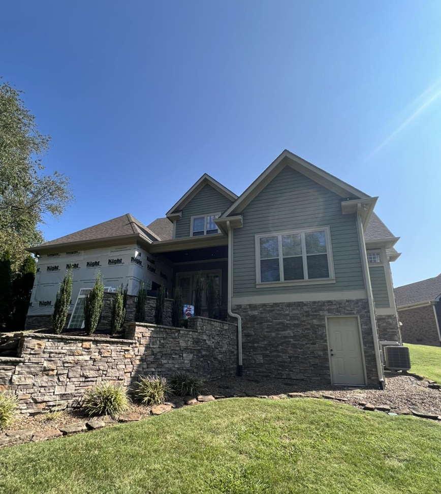 Exterior of a house undergoing siding installation and renovation by PrimeTime Painting in Bowling Green, KY.
