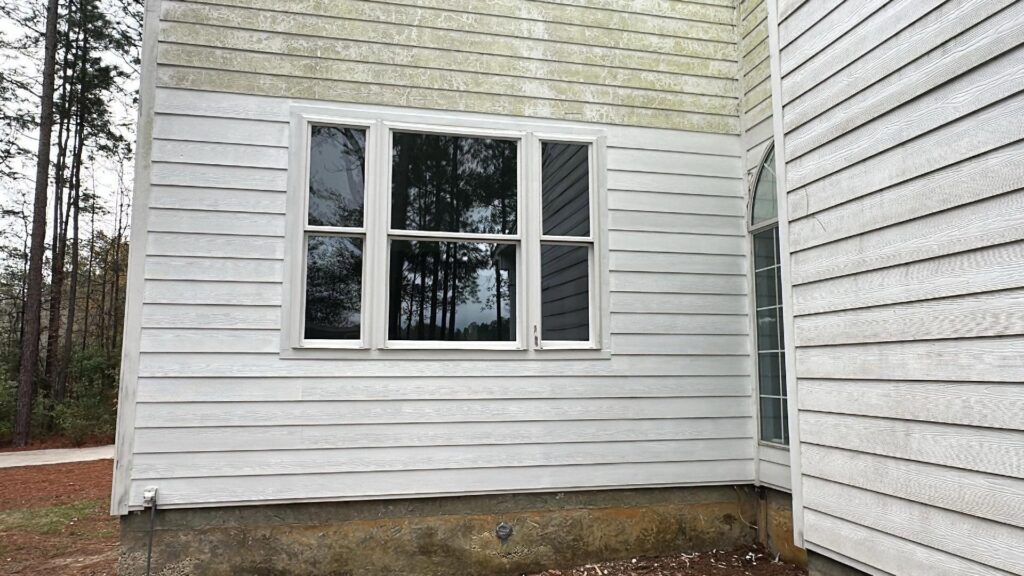 Exterior of a house with new windows installed and clean siding, demonstrating home improvement by SMM Services LLC in Gulfport, MS.