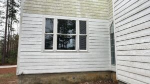 Exterior of a house with new windows installed and clean siding, demonstrating home improvement by SMM Services LLC in Gulfport, MS.