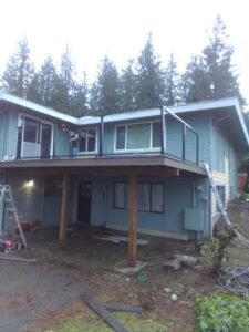 Exterior view of a house with a new deck under construction or recently completed by Guzmanremodeling LlC in Renton, WA.