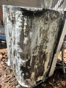 Exterior HVAC coils covered in cleaning foam during a service by ThermaPros in Leesburg, FL.