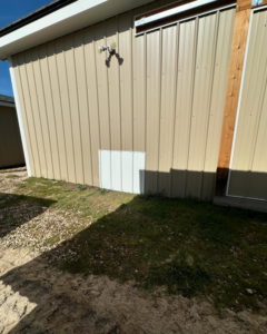 The exterior of a metal building with a repaired siding section by Syd's Handyman Services in Oxnard, CA.