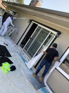 Workers from Kennyman The Handyman Inc. preparing an exterior wall for painting in San Francisco, CA