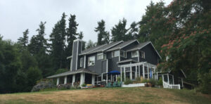A painter from Brush N' Roll Painting Co. painting the exterior porch trim in Federal Way, WA.