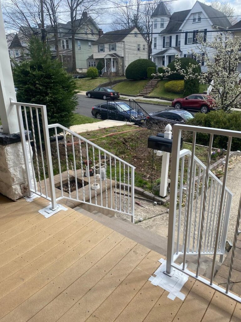 New white metal railings being installed on an exterior porch by Advanced Welding All in One Fabrication LLC in Guttenberg, NJ.