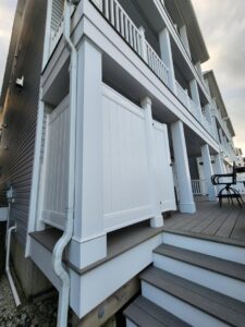 Newly installed exterior privacy screen and deck steps by Priority Property Services in Salisbury, MD.