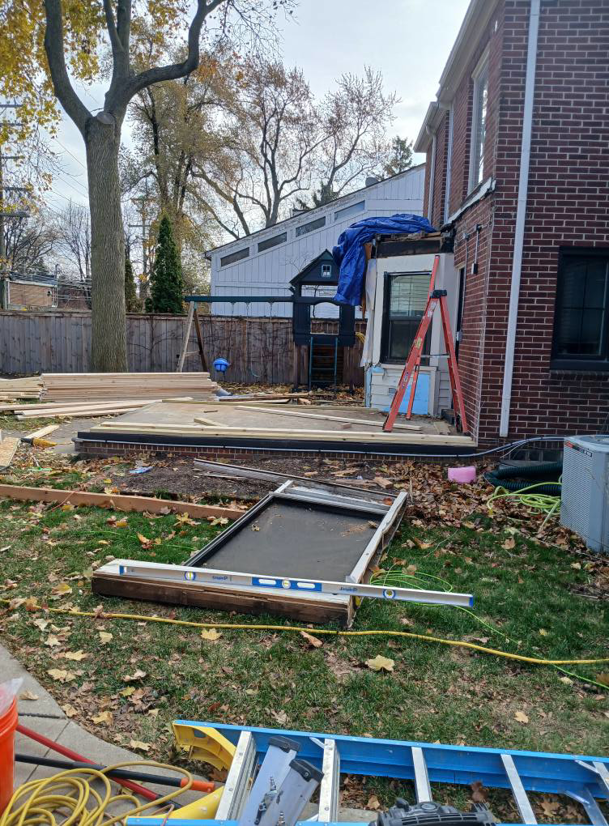 Exterior renovation project with deck construction materials at a home by Exterior Renovations, LLC in Clinton Township, MI.