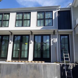 Exterior renovation of a house with new windows and doors being installed by Charleston Exteriors in Charleston, SC.