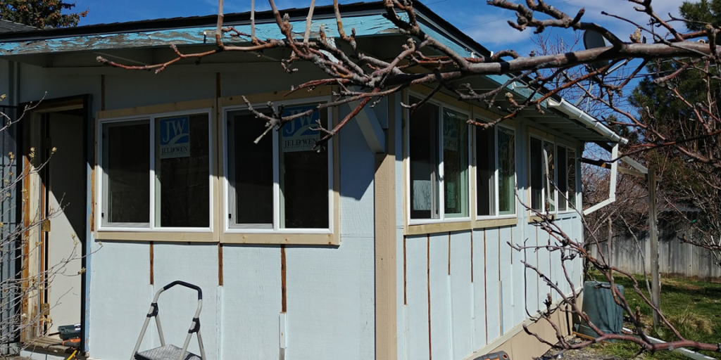 Exterior renovation of a building with new windows and siding work in progress by TNT Handyman Services LLC in Sparks, NV.