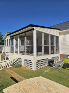 Exterior view of a screened porch under construction with tools and materials by TruBuilt Contracting LLC in Cary, NC