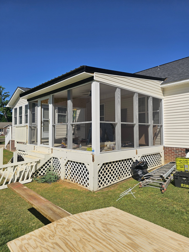 Exterior view of a screened porch under construction with tools and materials by TruBuilt Contracting LLC in Cary, NC