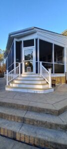 Exterior view of a newly built screened-in porch with steps by M&M Home Builders, LLC in Richmond, VA.