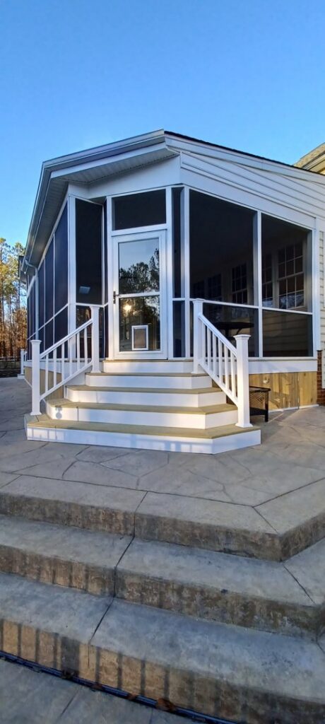 Exterior view of a newly built screened-in porch with steps by M&M Home Builders, LLC in Richmond, VA.