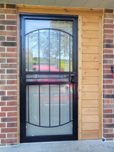 An exterior security screen door and new wood trim installed by The Handyman Gabriel in Madison, WI