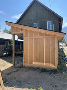 Exterior view of a newly constructed shed or addition, framed and partially sided by 1775 Handyman Services in Kalispell, MT.