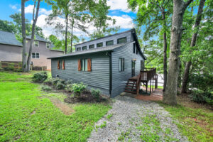 Exterior view of a house with new siding and a wooden deck by Lee's Painting in Northbrook, IL