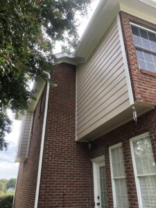 New exterior siding and gutter installation on a brick house by Lee's Painting in Northbrook, IL