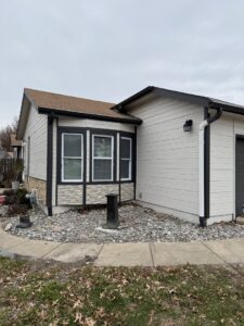 House exterior with new siding, gutters, and stone veneer installed by Gateway Home Services KC LLC in Kansas City, MO.