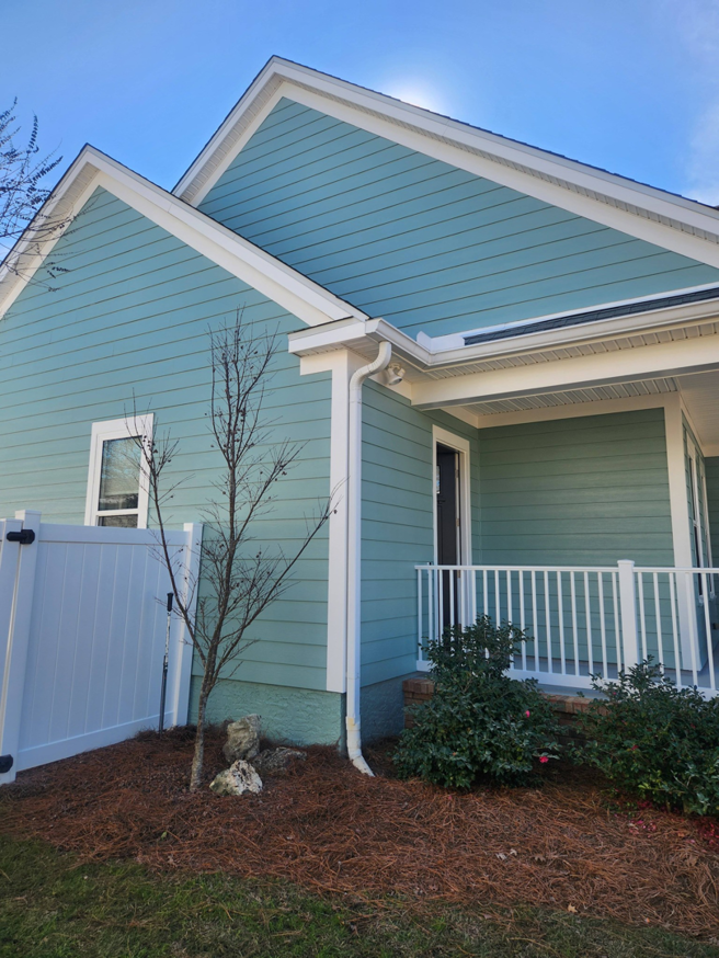 Exterior siding and trim painting on a light blue house by Oseguera Painting, LLC in Tallahassee, FL