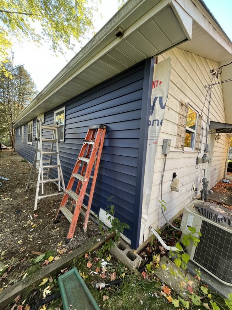 Exterior siding replacement in progress, showing new blue siding installed on a home by Midwest Home Remodeling & Design LLC in Chicago, IL.