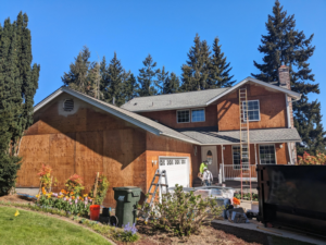 A house undergoing exterior siding replacement and roofing work by Lifetime Exterior Solutions, LLC in Kent, WA.