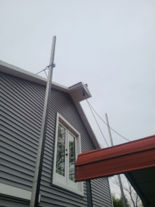 Exterior siding work with a material lift on a building by Jos Construction LLC in Trenton, NJ.