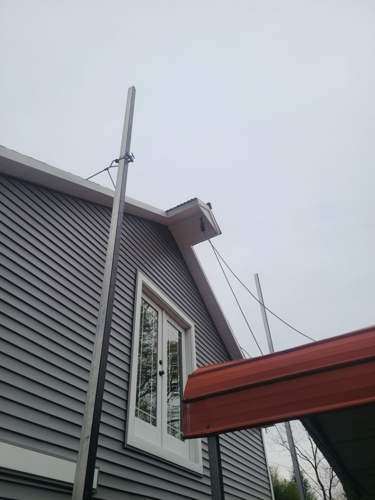 Exterior siding work with a material lift on a building by Jos Construction LLC in Trenton, NJ.