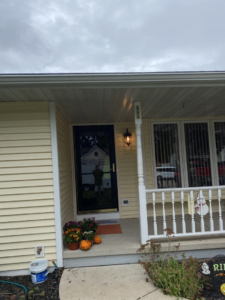An exterior view of a house featuring a new storm door installation by Urban Exteriors in Green Bay, WI.