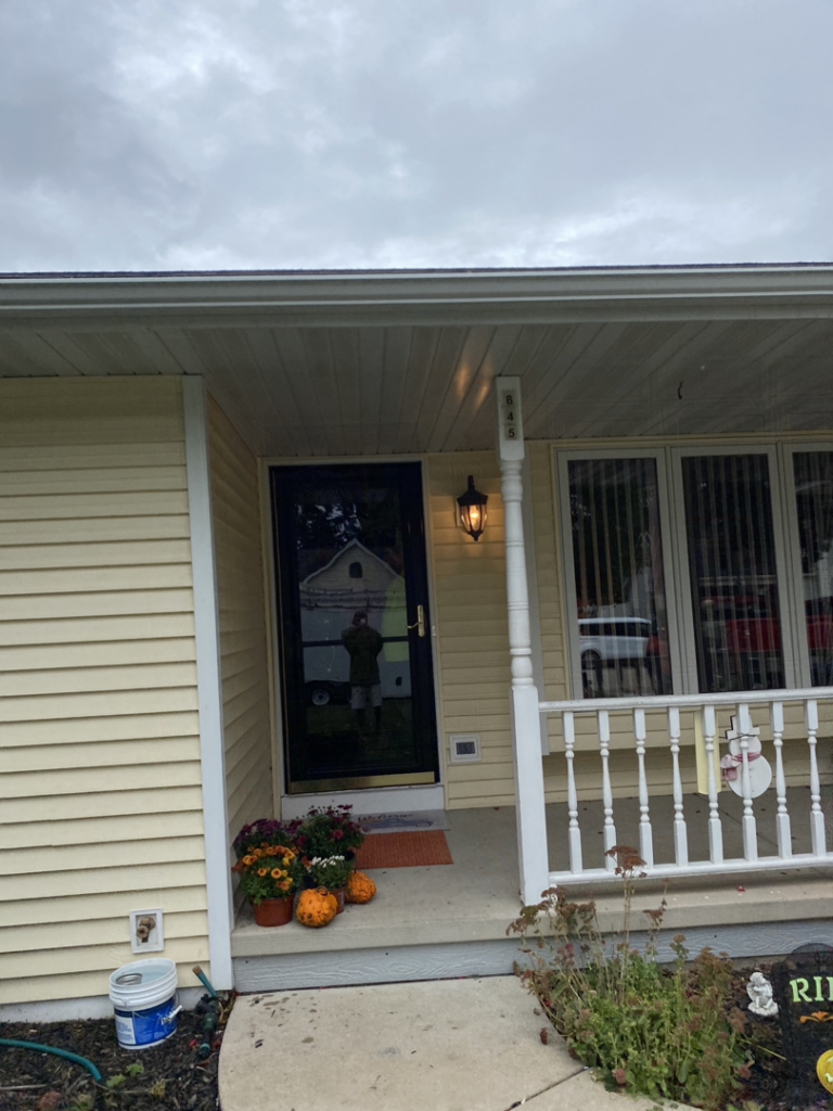 An exterior view of a house featuring a new storm door installation by Urban Exteriors in Green Bay, WI.