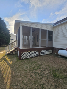 Exterior view of a newly built screened porch and deck structure by TruBuilt Contracting LLC in Cary, NC