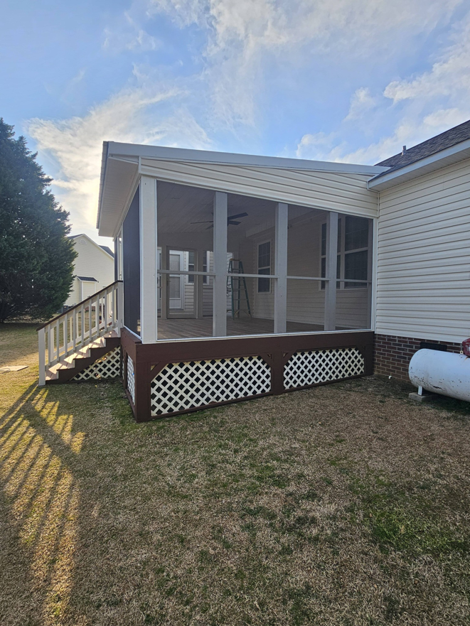 Exterior view of a newly built screened porch and deck structure by TruBuilt Contracting LLC in Cary, NC