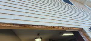Exterior wall with a large opening and damaged wood, indicating door or window frame repair by Ray's Property Services in Johnson City, TN