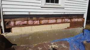 Exterior wall repair showing new insulation and sheathing installed by DiBenedetto Building & Remodeling in Worcester, MA.